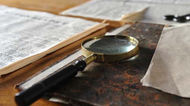 magnifying glass resting on a desk